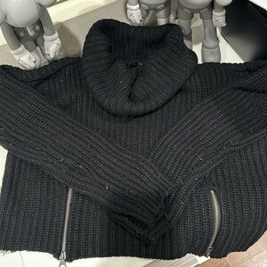 Aqua size medium black sweater with front bottom zipper details.